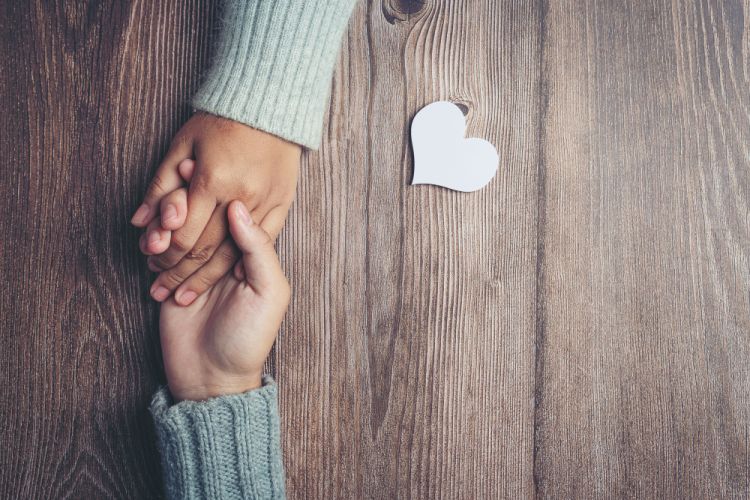 Hands joined in a gesture of support and help